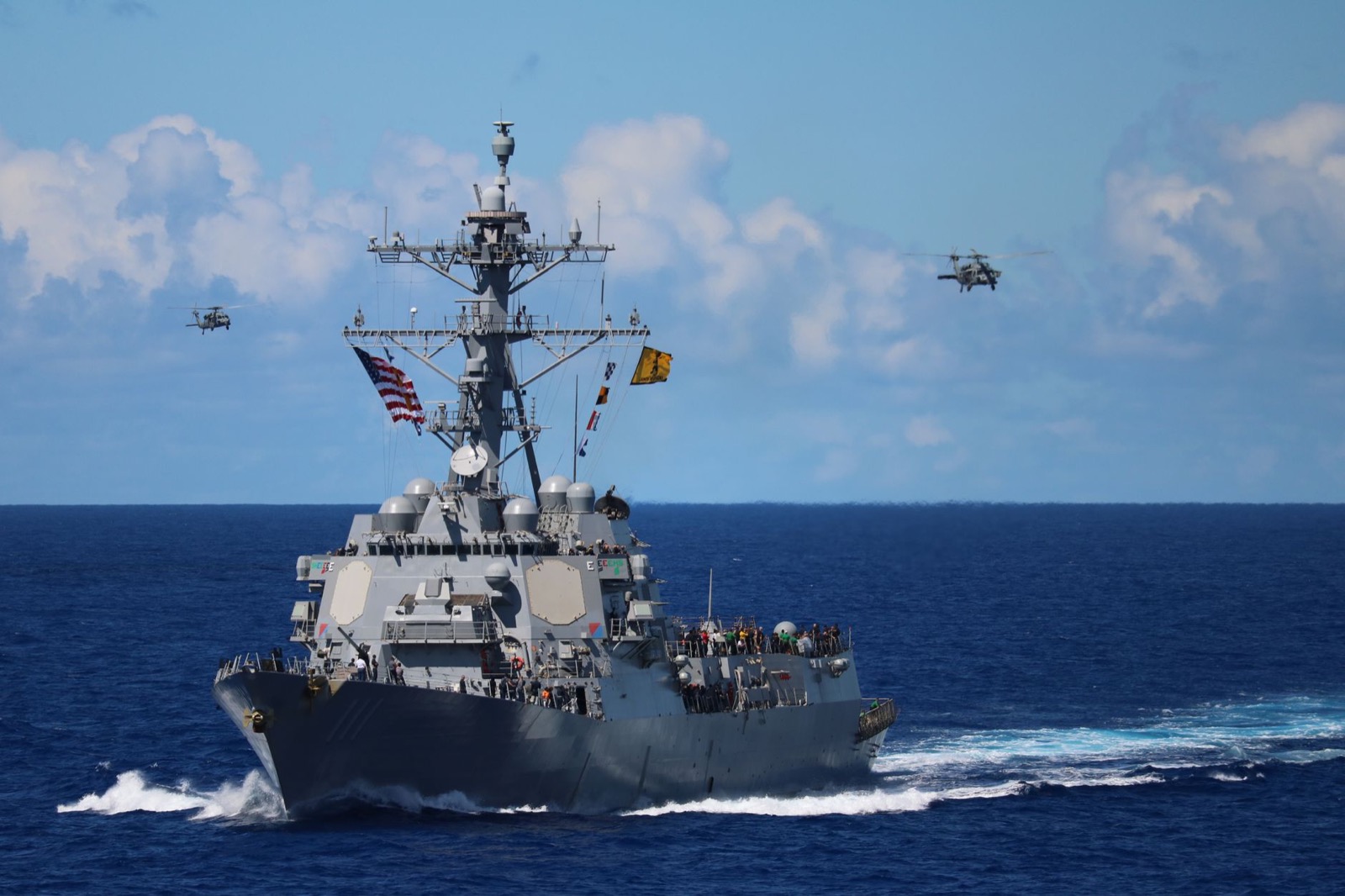 Naval vessel and fighter jets at sunset